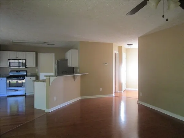 a view of kitchen and hall with wooden floor