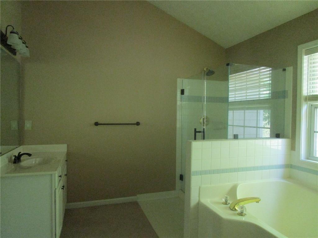 2825 Factor Walk Boulevard Suwanee, GA 30024 - Photo 15 of 25 a bathroom with a tub and shower