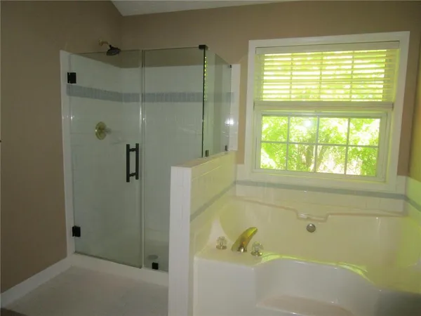 a bathroom with a bathtub and shower