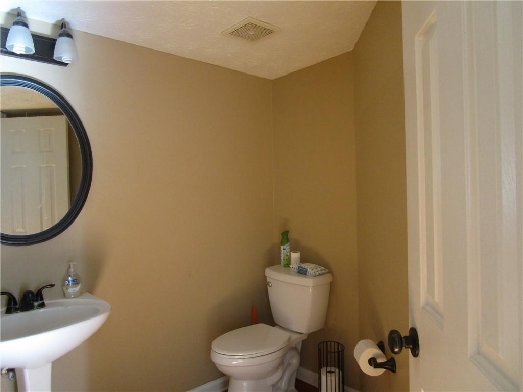 2825 Factor Walk Boulevard Suwanee, GA 30024 - Photo 23 of 25 a bathroom with a toilet sink and mirror