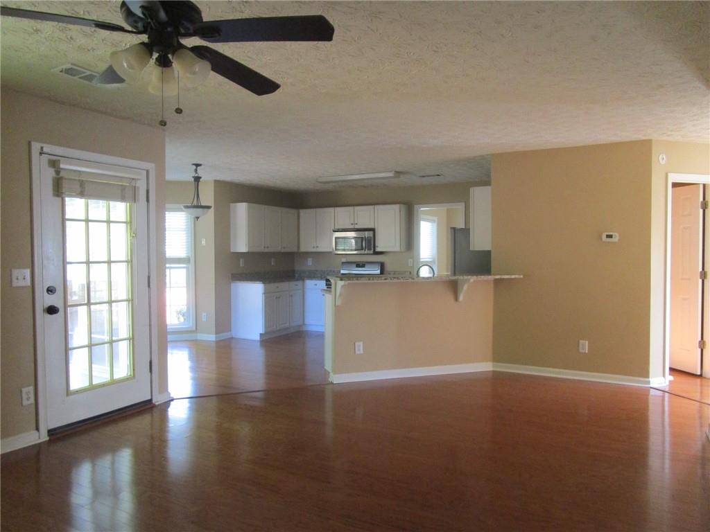 2825 Factor Walk Boulevard Suwanee, GA 30024 - Photo 7 of 25 a view of a kitchen with a dishwasher cabinets and a floor to ceiling window