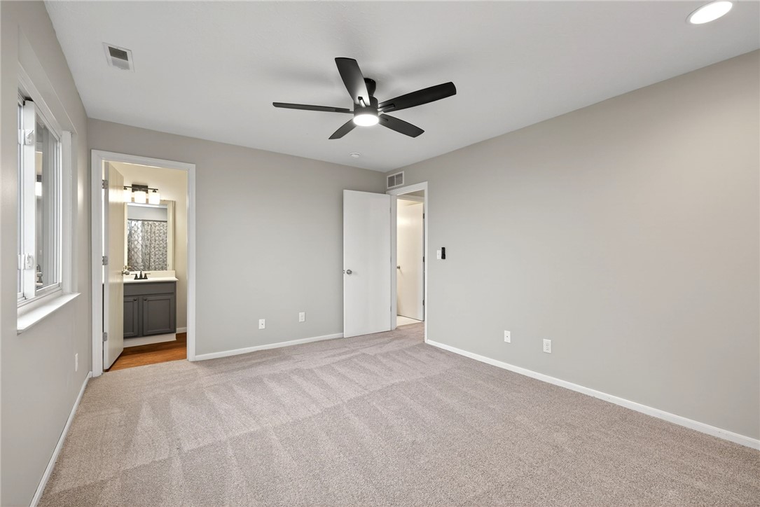 3151 Roesch Boulevard, Unit 6 Fairfield, OH 45014 - Photo 20 of 29 This spacious bedroom offers comfortable carpeting and convenient access to a private bathroom.