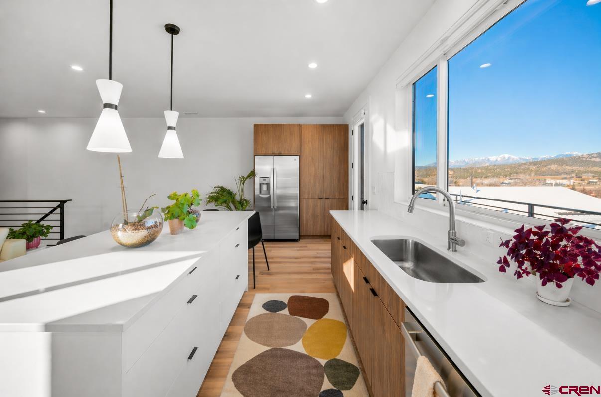 213 Treeline Street Durango, CO 81303 - Photo 2 of 41 a kitchen with stainless steel appliances kitchen island granite countertop a sink and a stove