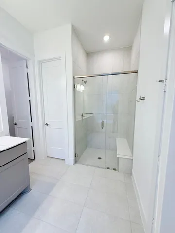 a bathroom with a shower and a sink