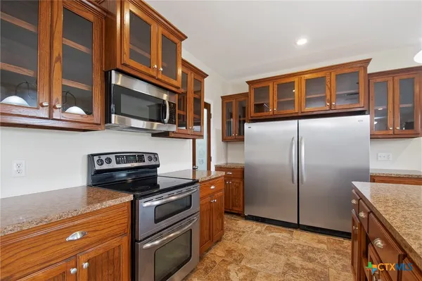 an empty room with windows and ceiling fan