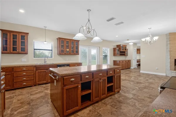 a view of an empty room with a window and bathroom