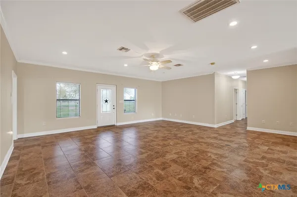 a view of kitchen with stainless steel appliances granite countertop cabinets and a dresser