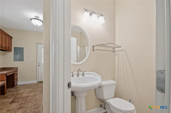a bathroom with a granite countertop sink a mirror and a vanity