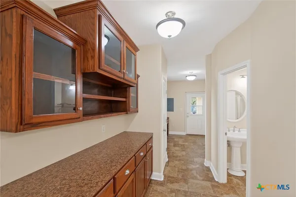 an empty room with closet and a chandelier fan
