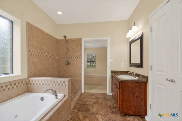 a kitchen with stainless steel appliances granite countertop a refrigerator a stove and a sink