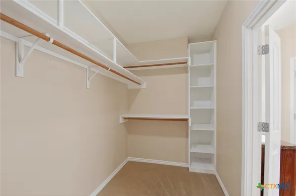 a kitchen with stainless steel appliances granite countertop a refrigerator a stove and a sink with wooden floor