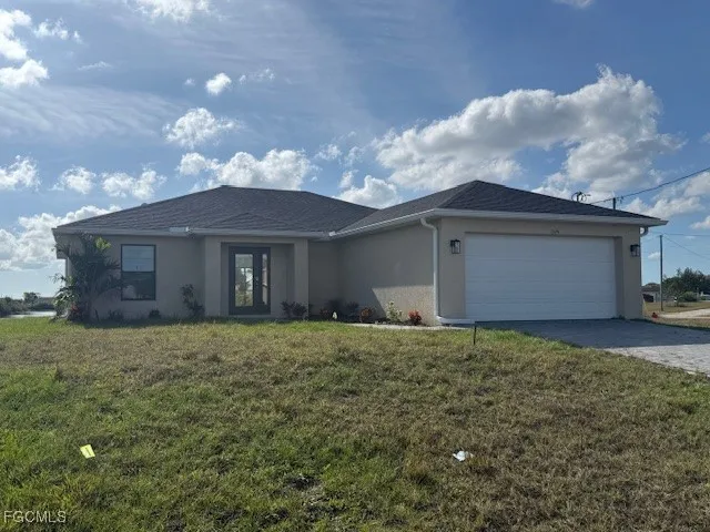 a view of a house with a yard and garage