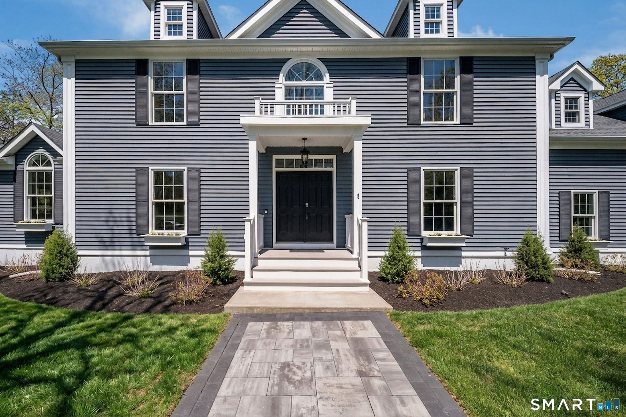 9 Sunset Ridge Drive Guilford, CT 06437 - Photo 3 of 40 a front view of a house with a yard and potted plants