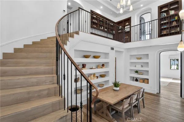 a view of hallway with wooden floor and stairs