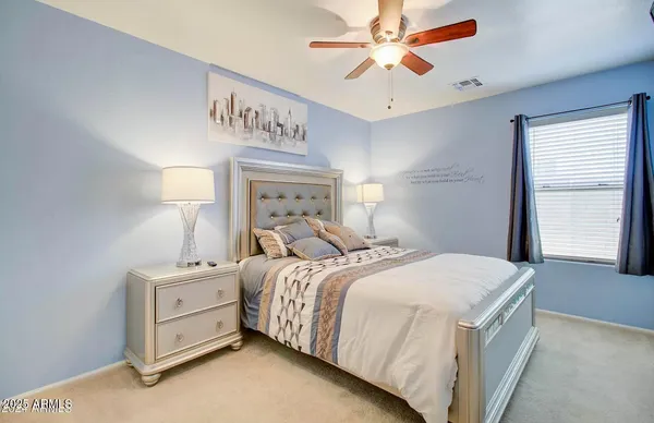a bedroom with a bed and a ceiling fan