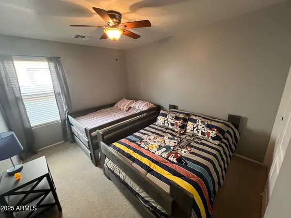 a bedroom with bed and a window