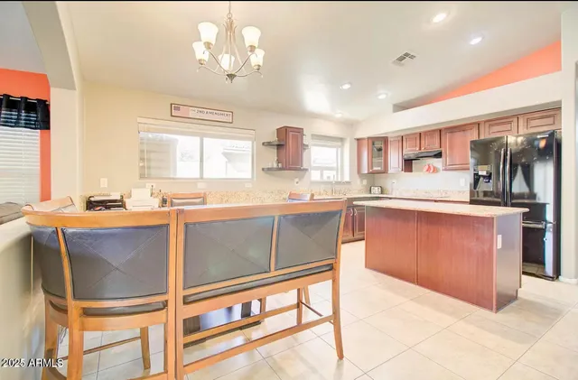 a kitchen with stainless steel appliances granite countertop a stove and a sink