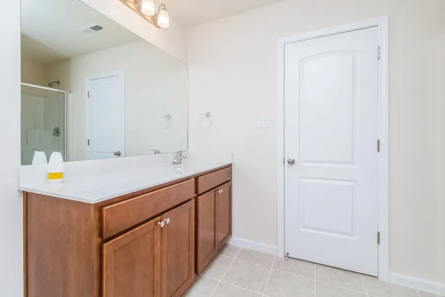 a bathroom with a sink a mirror and a vanity