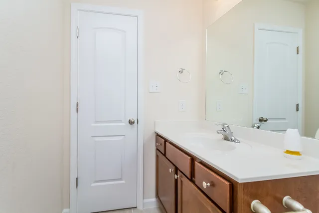 a bathroom with a sink vanity and a mirror
