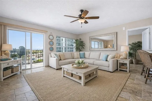 a living room with furniture and large windows