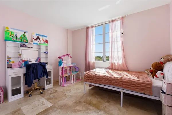 a bedroom with a bed and a table in it