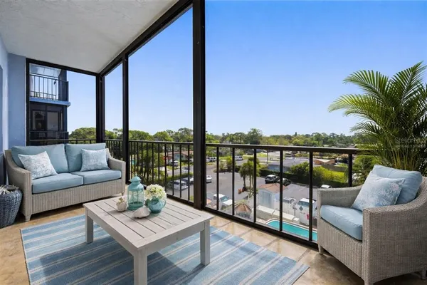 a living room with furniture and a view of kitchen