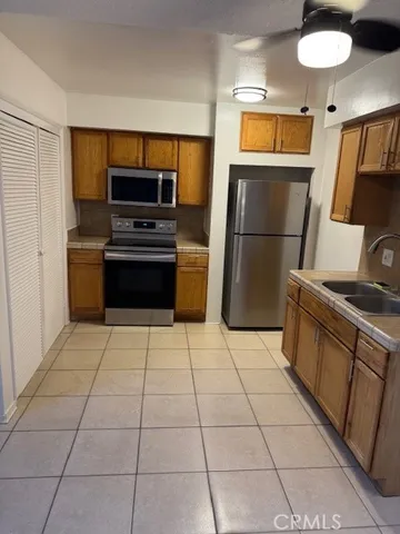 a kitchen with a stove a microwave and a refrigerator