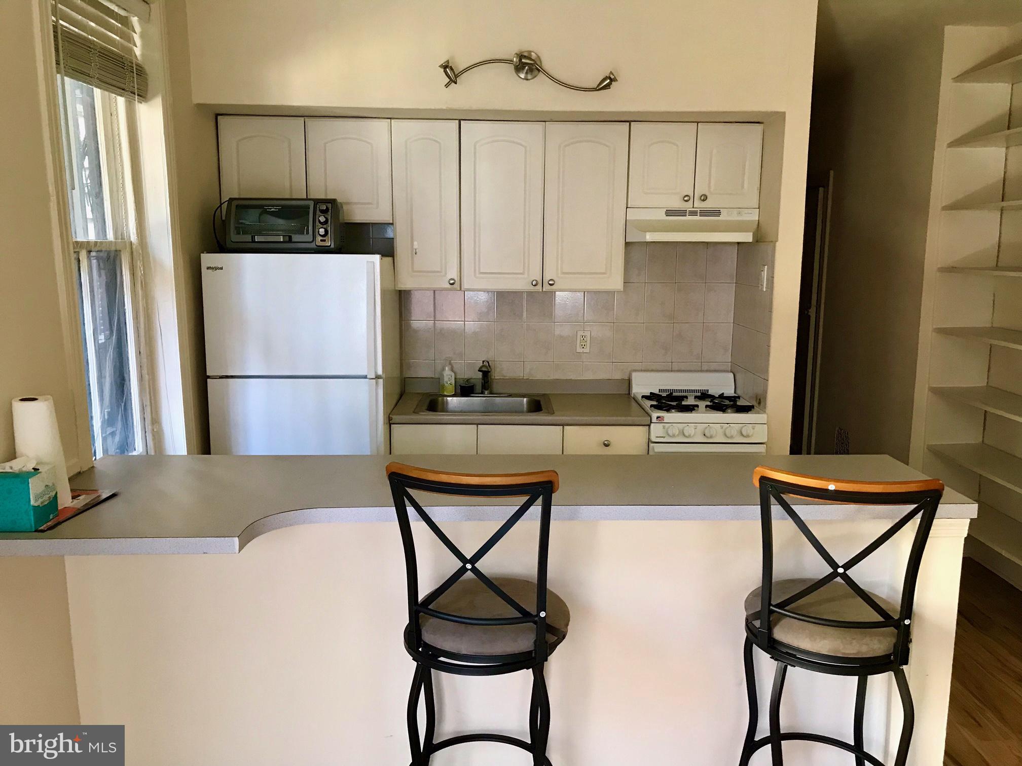 312 South 12th Street, Unit 1RR Philadelphia, PA 19107 - Photo 3 of 13 a kitchen with stainless steel appliances granite countertop a refrigerator and a stove top oven
