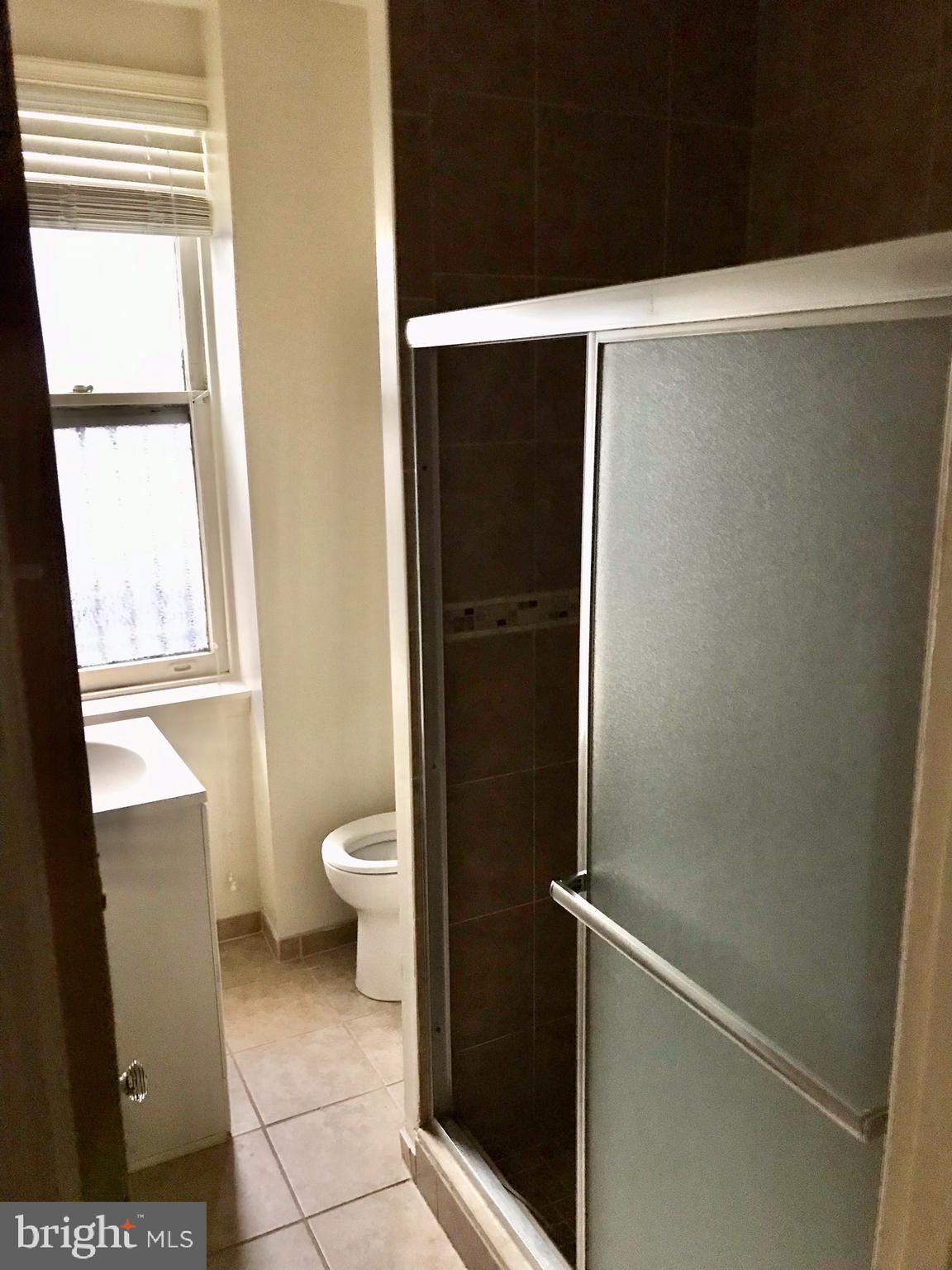 312 South 12th Street, Unit 1RR Philadelphia, PA 19107 - Photo 7 of 13 a bathroom with a granite countertop sink toilet and shower