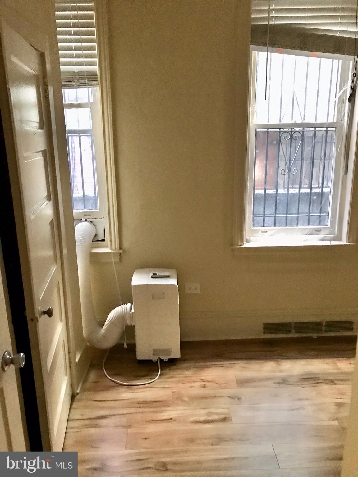 312 South 12th Street, Unit 1RR Philadelphia, PA 19107 - Photo 10 of 13 a living room with furniture and a window
