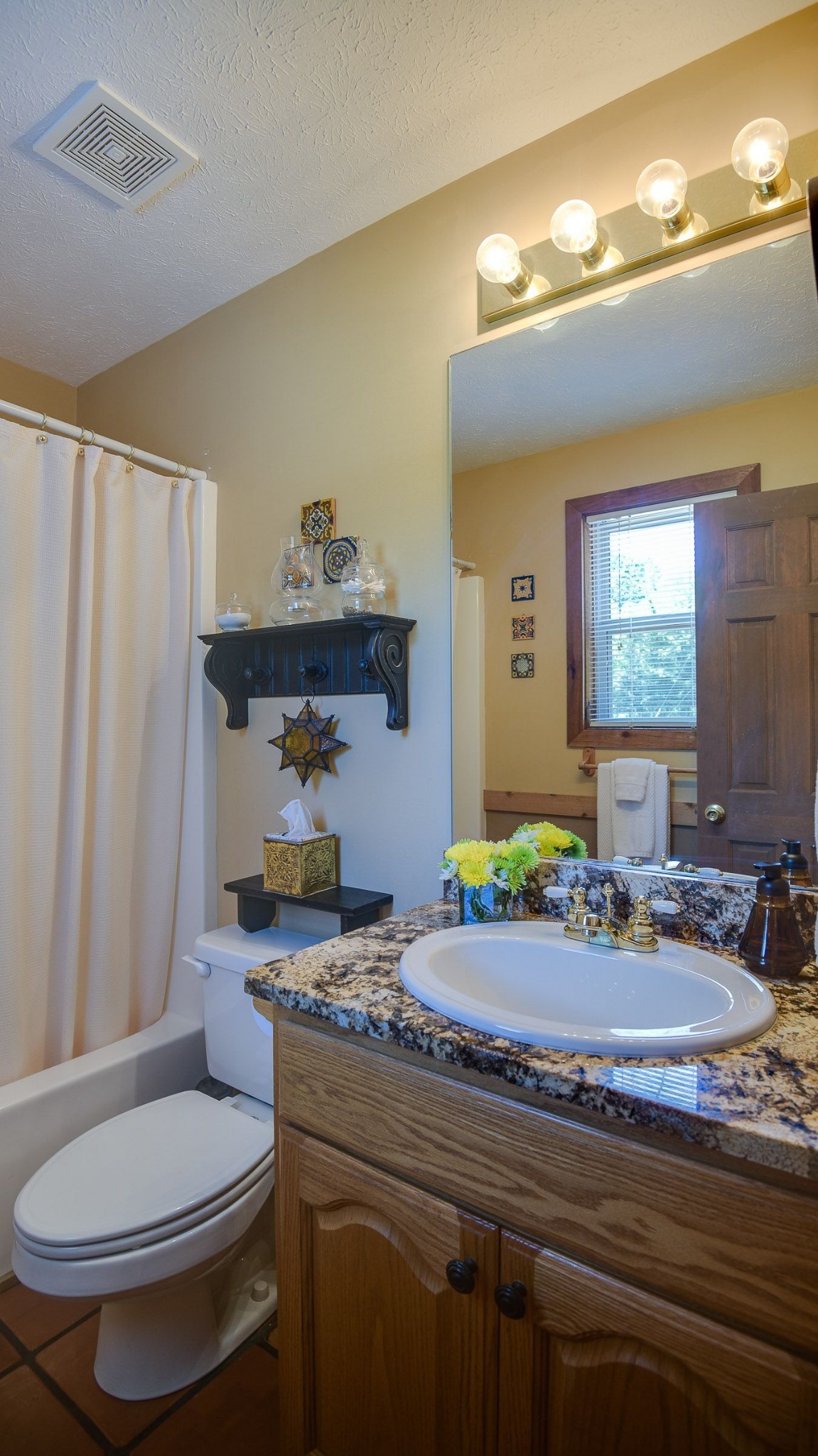 649 Lock 5 Road Lebanon, TN 37087 - Photo 34 of 65 a bathroom with a granite countertop toilet sink and mirror