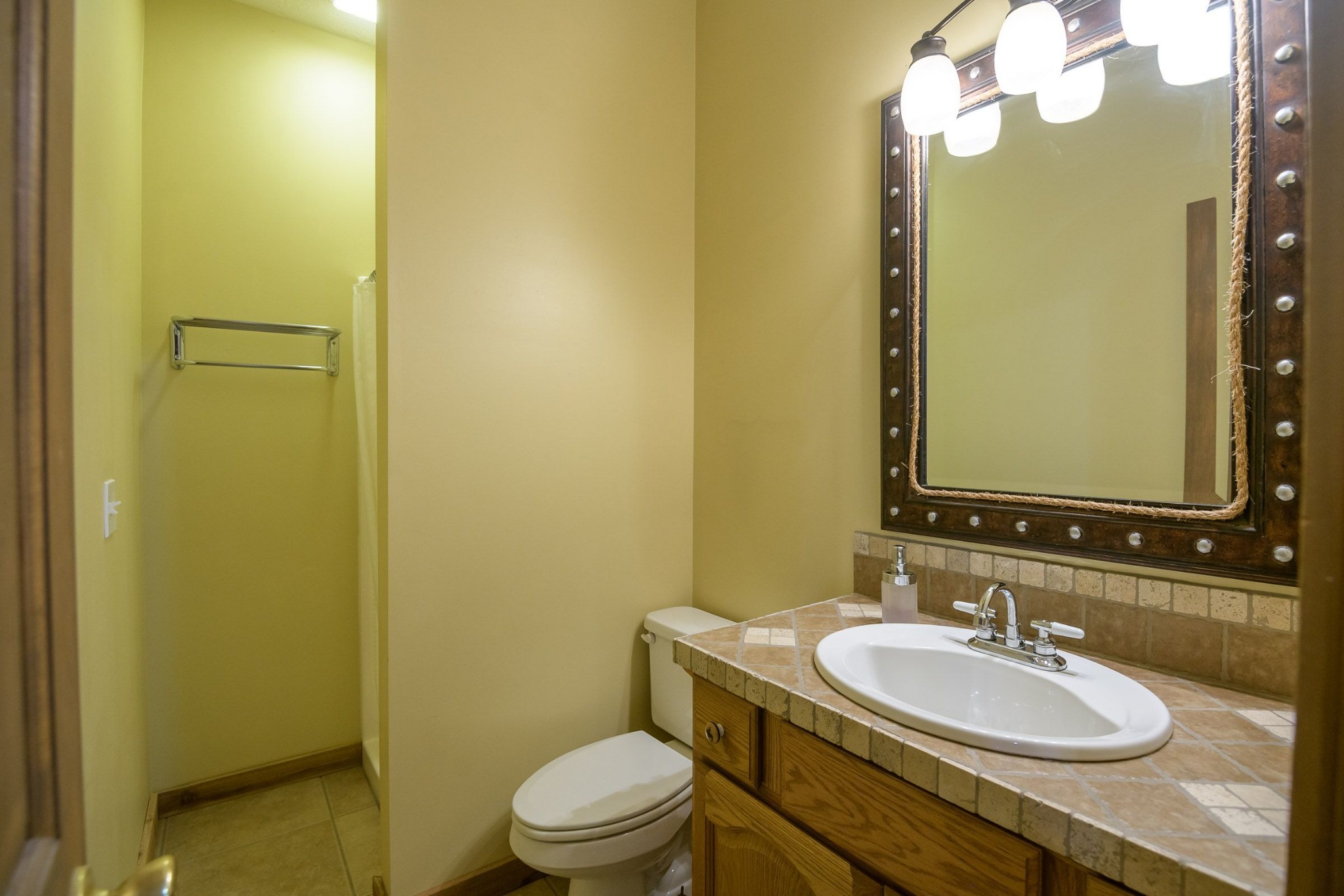 649 Lock 5 Road Lebanon, TN 37087 - Photo 48 of 65 a bathroom with a granite countertop sink toilet and a mirror