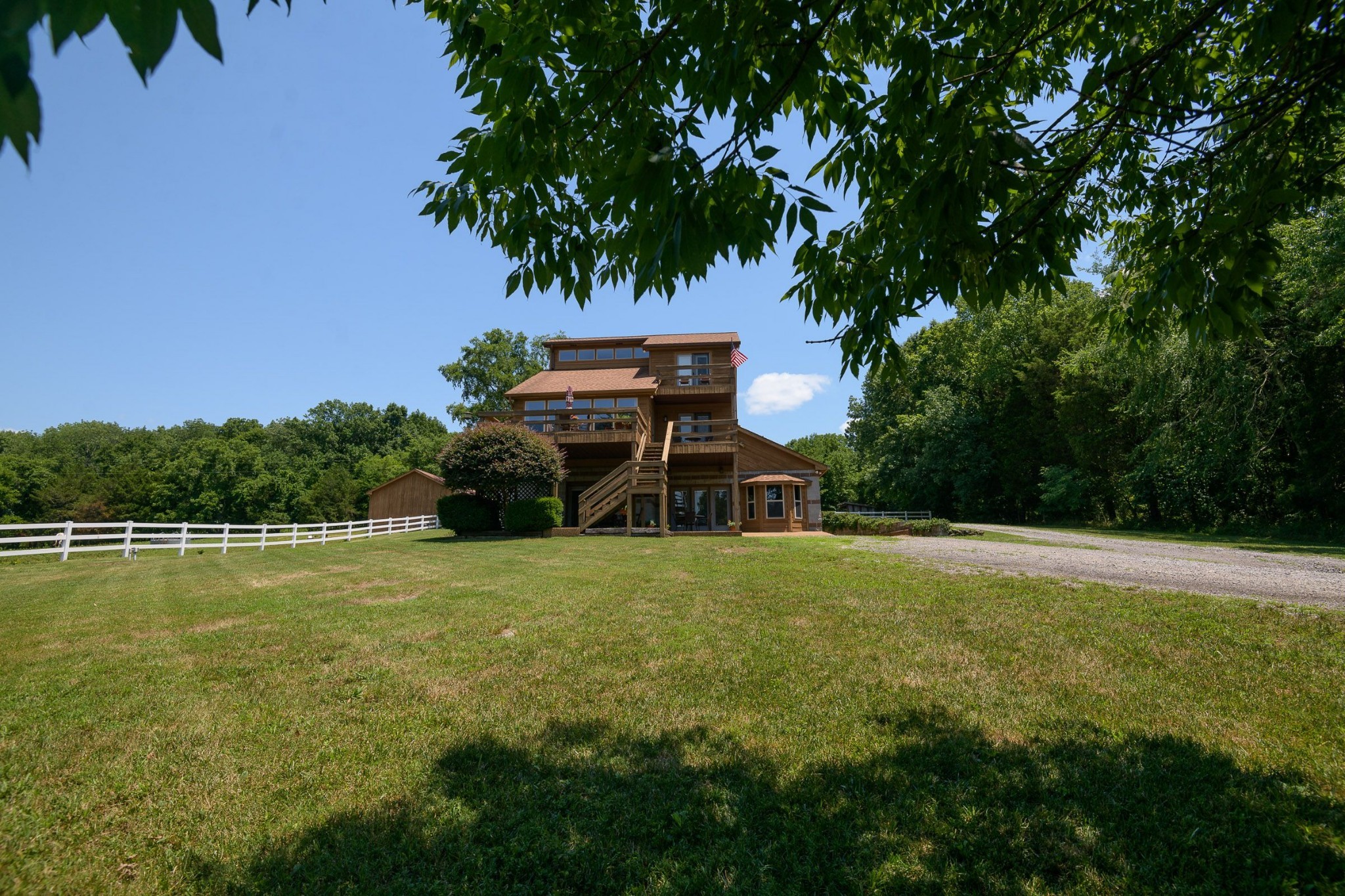 649 Lock 5 Road Lebanon, TN 37087 - Photo 5 of 65 a backyard of a house with table and chairs under an umbrella
