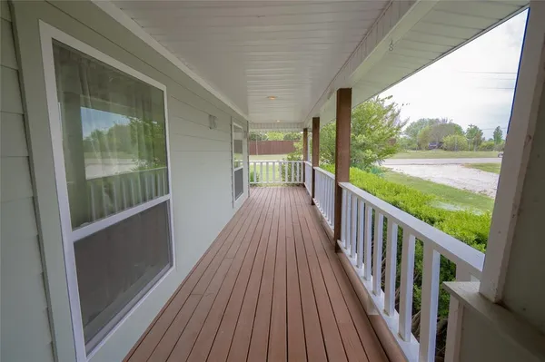 a view of a balcony with wooden floor