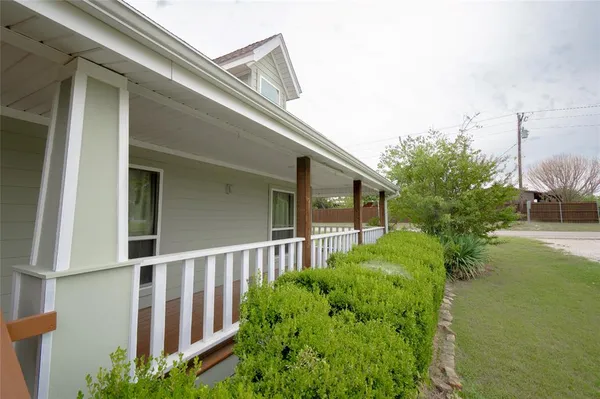 a view of a house with a small yard and plants