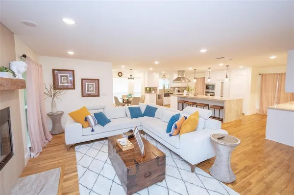 a hallway with wooden floor and a chandelier