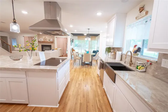 a living room with furniture and a kitchen view