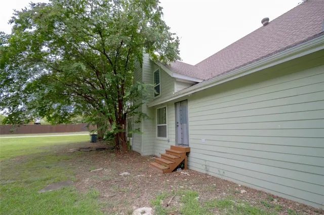 a backyard of a house with table and chairs