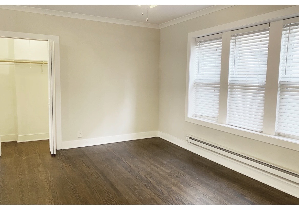 4218 North Clark Street, Unit 2 Chicago, IL 60613 - Photo 9 of 12 an empty room with wooden floor and windows