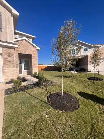 a view of a house with backyard and sitting area