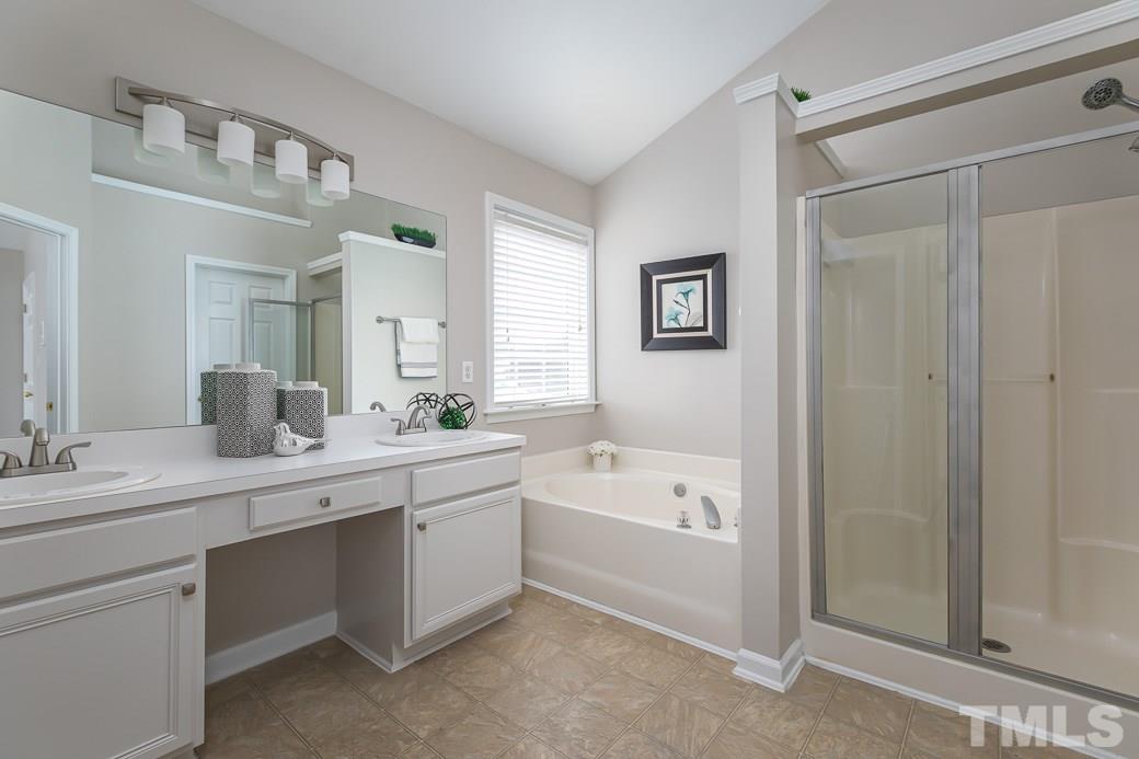 5400 Cahaba Way Raleigh, NC 27616 - Photo 7 of 13 The Master Bathroom features NEW FIXTURES, a spacious vanity with two sinks and a separate shower. There is a GARDEN TUB with a large window which allows natural light to flood the room creating a peaceful atmosphere.