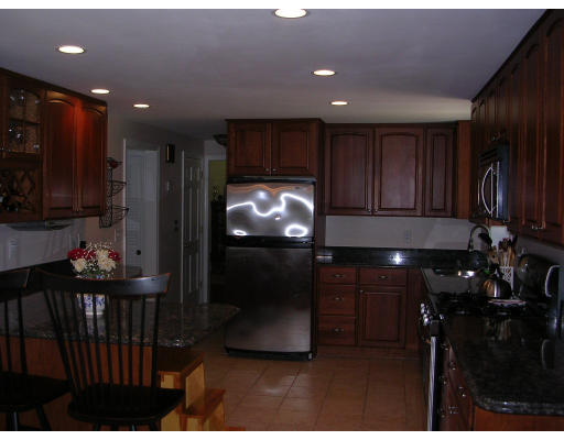 55 Box Mill Road Boxborough, MA 01719 - Photo 9 of 16 a kitchen with a refrigerator and a stove
