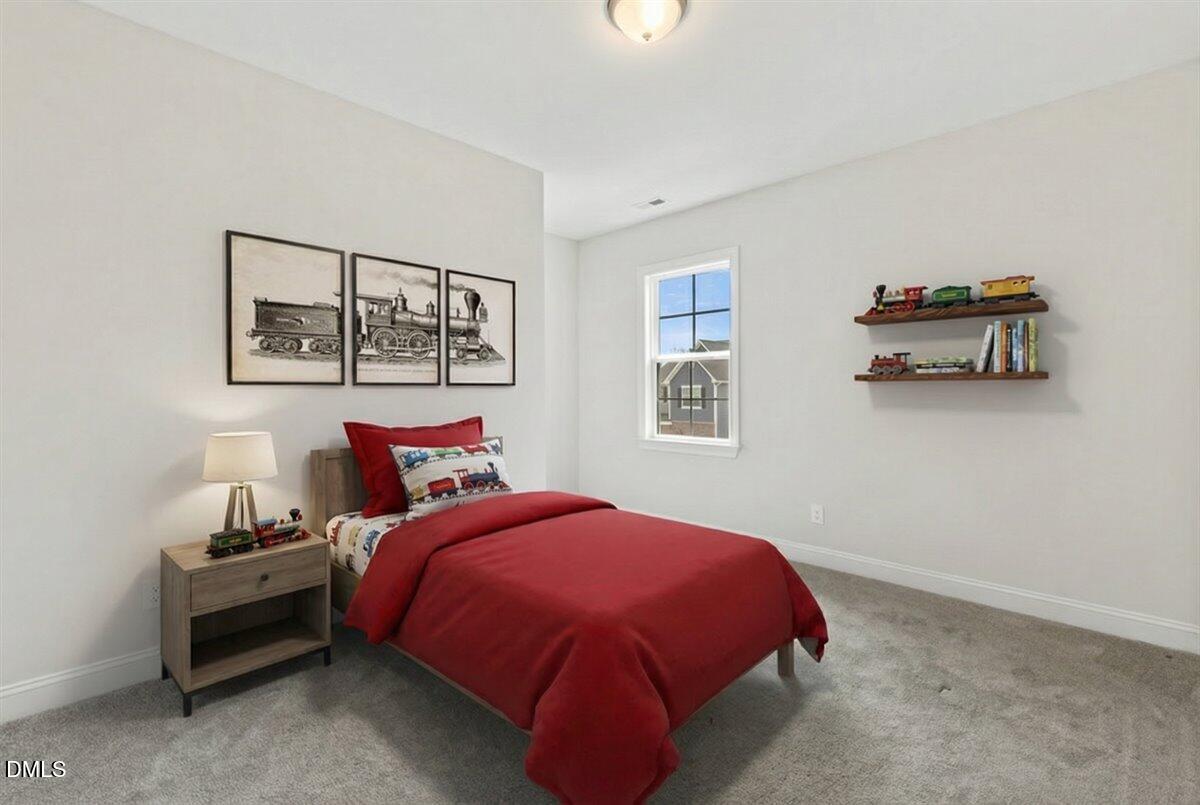 4937 Abundance Avenue Raleigh, NC 27616 - Photo 24 of 36 a bed room with a bed and a painting on the wall