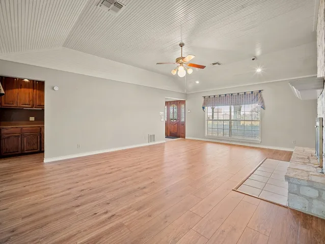 a kitchen with stainless steel appliances granite countertop a stove a sink dishwasher and a microwave oven with cabinets