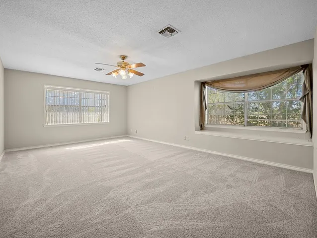 a spacious bathroom with a tub sink and mirror