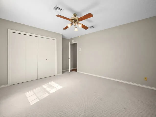 a view of cabinets a wooden floor and windows