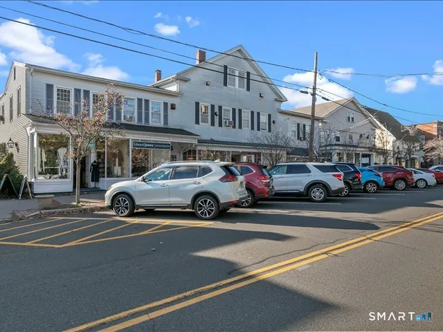 a view of a cars park in front of a building