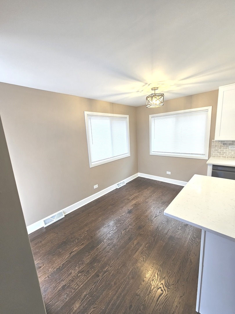 14926 Kenton Avenue Midlothian, IL 60445 - Photo 10 of 20 an empty room with wooden floor and windows