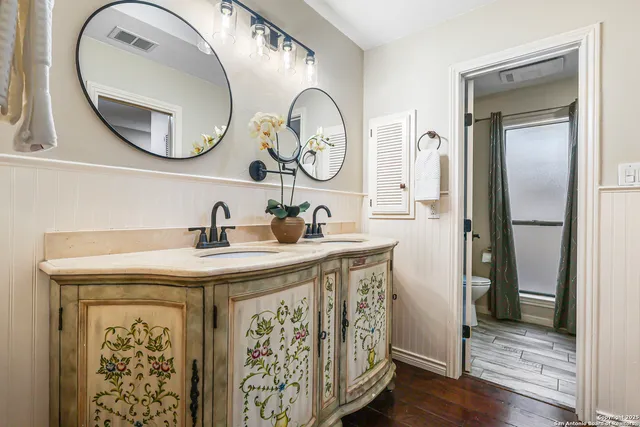 a bathroom with a granite countertop a sink and a mirror