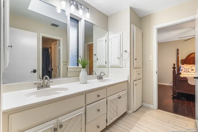 a bathroom with a double vanity sink and a mirror